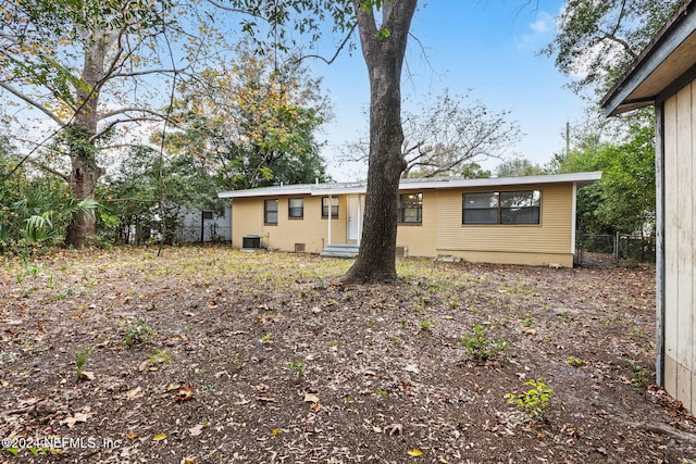 back of house with central AC unit