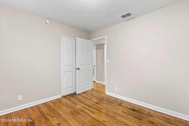 unfurnished bedroom featuring hardwood / wood-style flooring