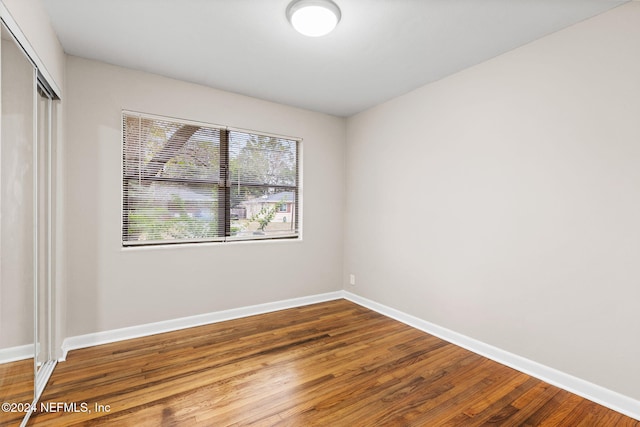 spare room with wood-type flooring