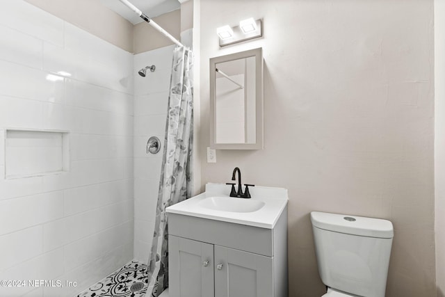 bathroom featuring vanity, toilet, and curtained shower