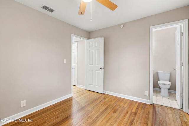 unfurnished bedroom featuring ceiling fan, connected bathroom, and light hardwood / wood-style flooring