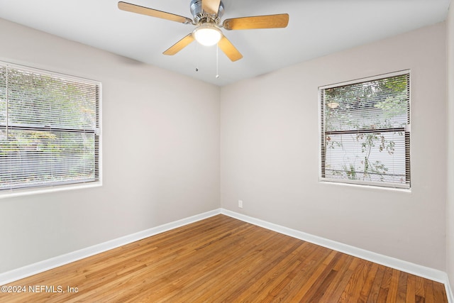 empty room featuring hardwood / wood-style flooring, plenty of natural light, and ceiling fan