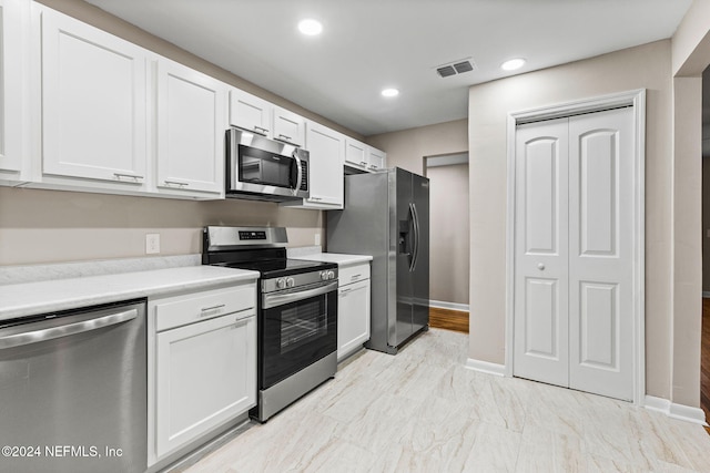 kitchen featuring white cabinetry and appliances with stainless steel finishes