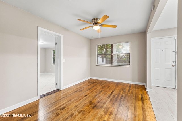 empty room with ceiling fan and wood-type flooring