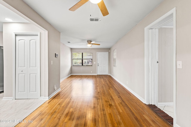 unfurnished living room with ceiling fan and light hardwood / wood-style floors