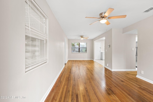 unfurnished living room featuring hardwood / wood-style flooring and ceiling fan