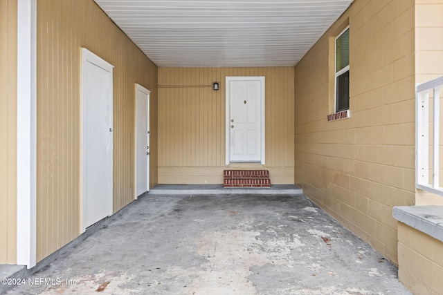 doorway to property with a carport