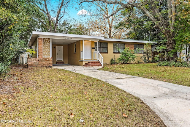 ranch-style home featuring a front yard and a carport