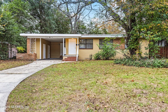 single story home featuring a front lawn and a carport