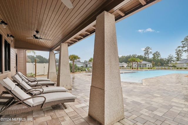 view of patio featuring ceiling fan and a community pool