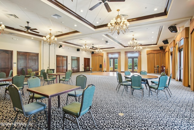 dining room with ceiling fan, a tray ceiling, and crown molding