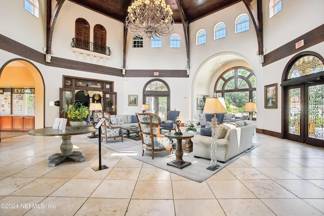 8495 Little Swift Cir, Jacksonville, FL 32256 - tiled living room featuring a notable chandelier, wood ceiling, french doors, and a healthy amount of sunlight