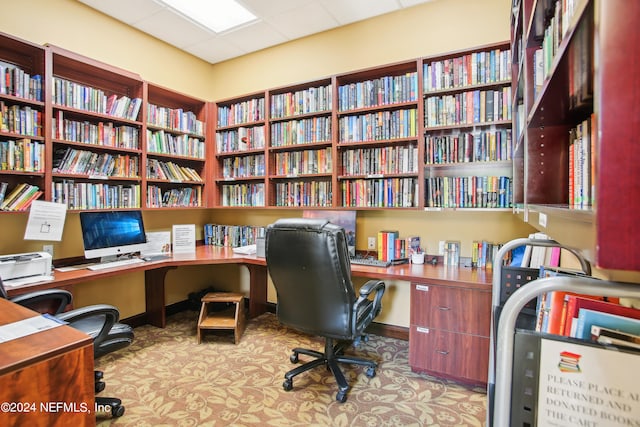 home office with a paneled ceiling