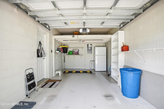 garage with a garage door opener and white fridge