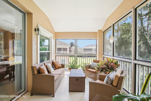 sunroom with vaulted ceiling, ceiling fan, and a healthy amount of sunlight