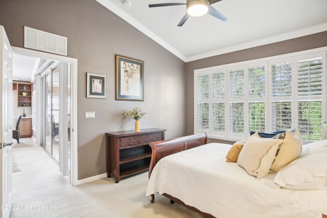 carpeted bedroom with ceiling fan, lofted ceiling, and ornamental molding