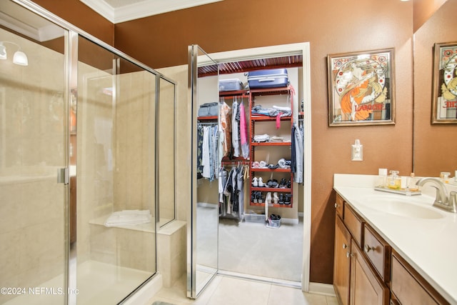 bathroom featuring crown molding, tile patterned flooring, vanity, and an enclosed shower