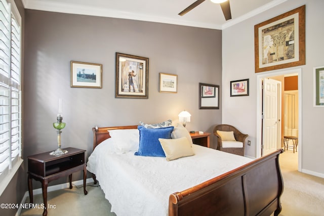 carpeted bedroom featuring ceiling fan and ornamental molding