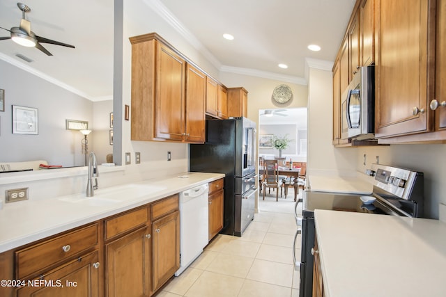 kitchen with light tile patterned flooring, sink, stainless steel appliances, crown molding, and ceiling fan