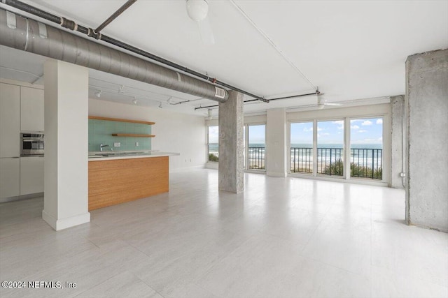 interior space featuring a water view and ceiling fan