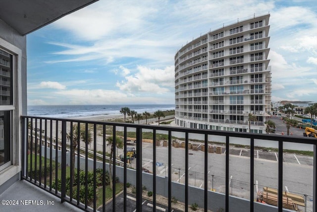 balcony featuring a beach view and a water view