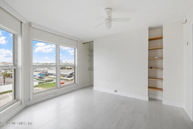 unfurnished room with light hardwood / wood-style flooring and ceiling fan