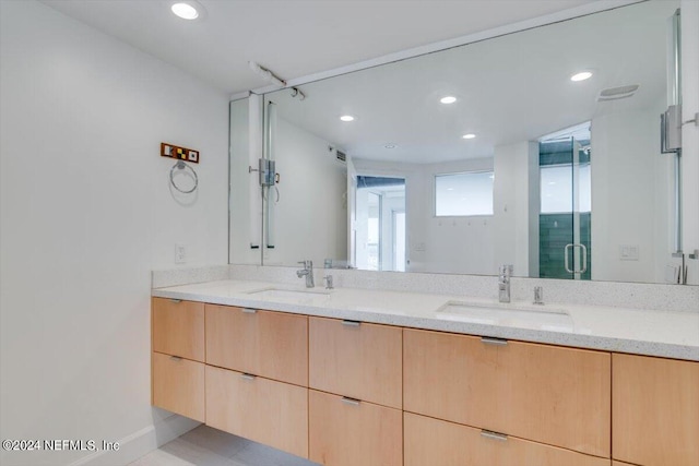 bathroom featuring vanity and an enclosed shower