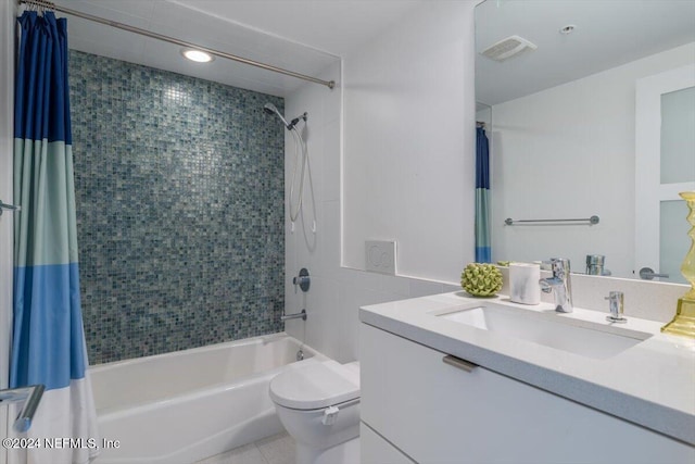 full bathroom featuring tile patterned flooring, shower / bath combo with shower curtain, vanity, and toilet