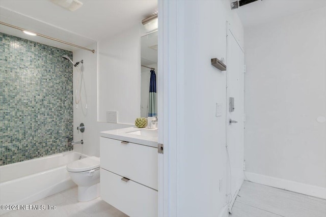 full bathroom with tile patterned floors, vanity, toilet, and tiled shower / bath combo