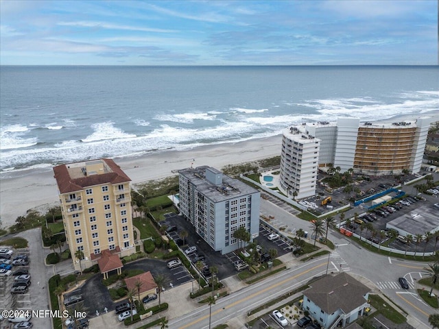 birds eye view of property featuring a beach view and a water view