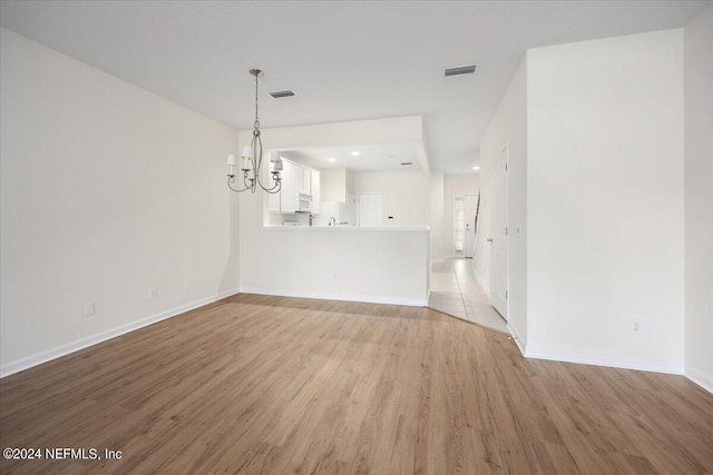 interior space featuring light hardwood / wood-style flooring and a chandelier