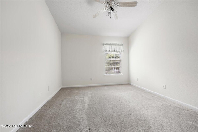 spare room with ceiling fan and carpet flooring