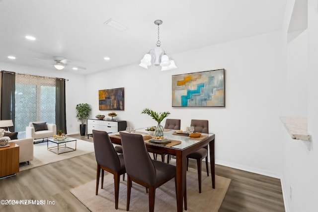 dining space with recessed lighting, baseboards, and wood finished floors