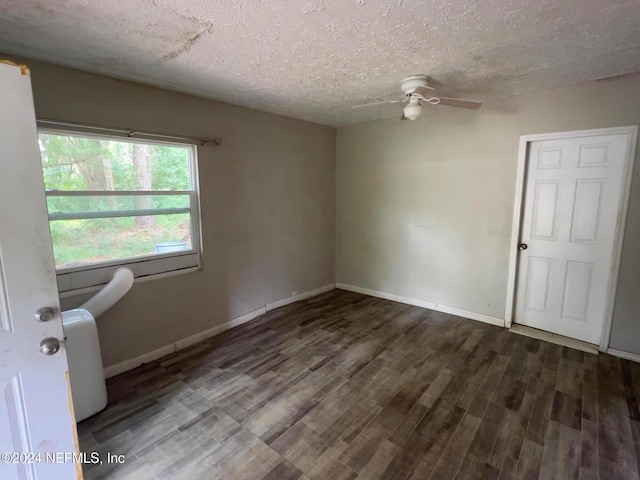 unfurnished room with a textured ceiling, dark hardwood / wood-style flooring, and ceiling fan