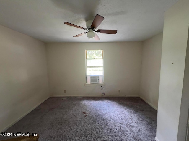 empty room featuring ceiling fan, cooling unit, and dark colored carpet