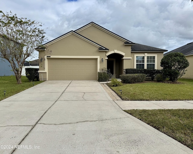 ranch-style home featuring a garage and a front lawn