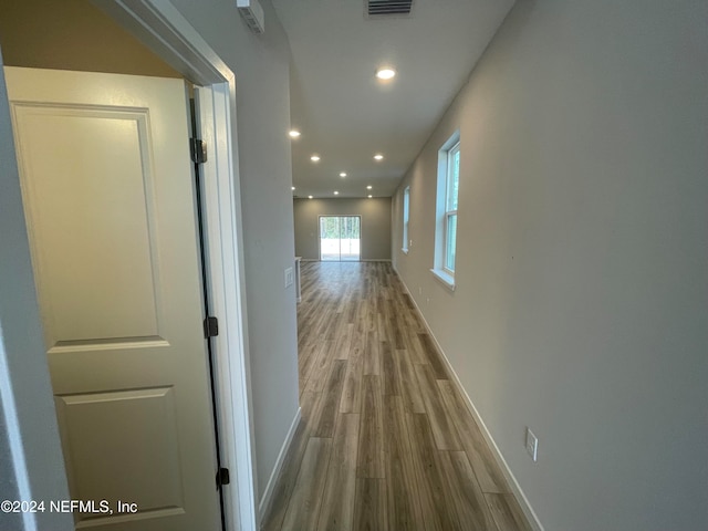 corridor with wood-type flooring