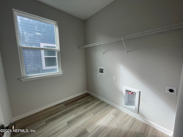 laundry room with hookup for an electric dryer, a wealth of natural light, hookup for a washing machine, and light hardwood / wood-style flooring