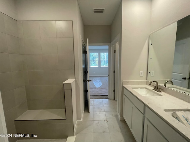 bathroom featuring vanity and a tile shower