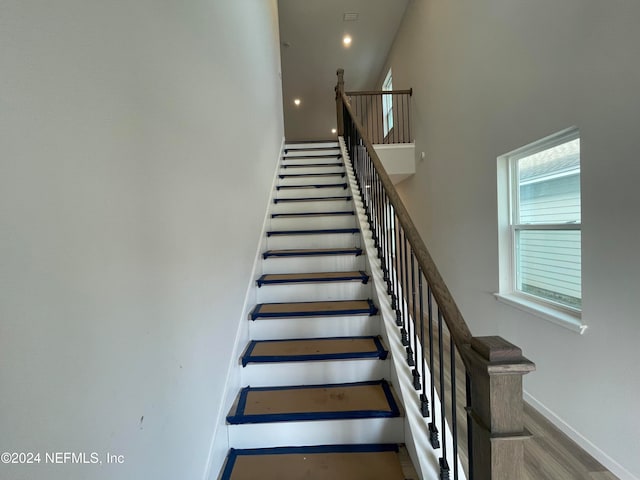 staircase featuring a towering ceiling