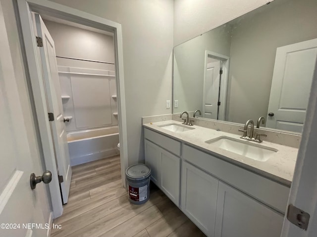 full bathroom featuring toilet, washtub / shower combination, vanity, and wood-type flooring