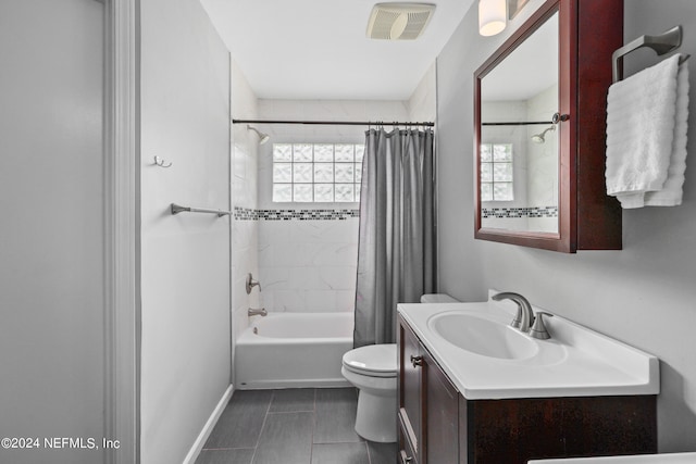 full bathroom featuring shower / bath combo, vanity, and toilet