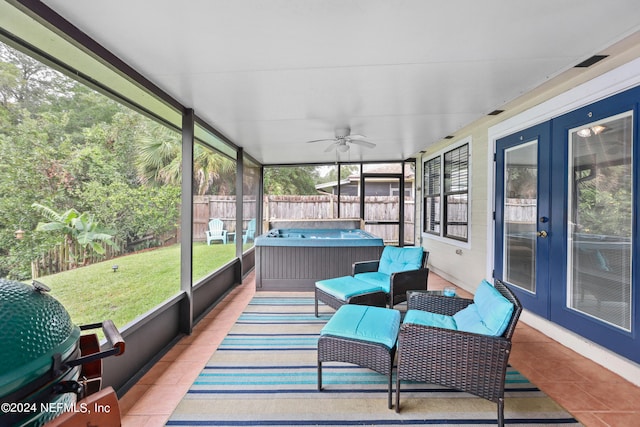 sunroom featuring ceiling fan and french doors