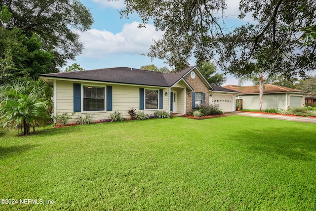 single story home with a front yard and a garage