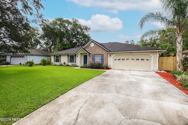 single story home featuring a front lawn and a garage