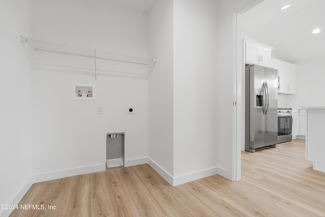 washroom with hookup for a washing machine, light hardwood / wood-style floors, and electric dryer hookup