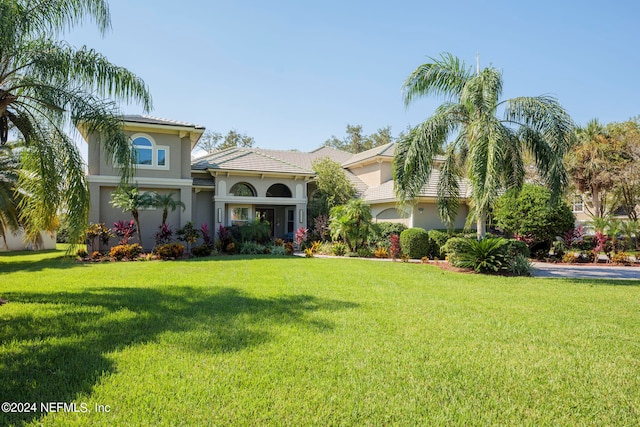 mediterranean / spanish-style house with a front lawn