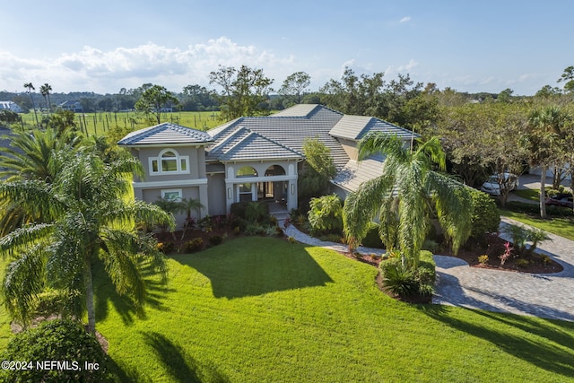 mediterranean / spanish-style home with a front lawn