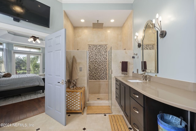 bathroom with vanity, a tile shower, tile patterned flooring, ceiling fan, and french doors