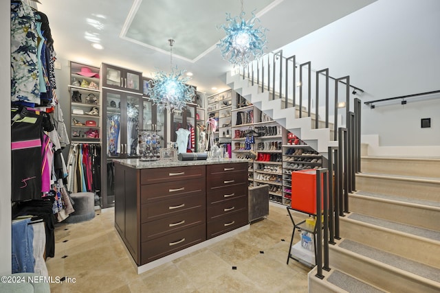 spacious closet featuring a chandelier